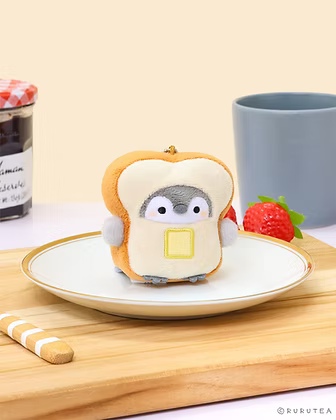 Koupen Chan Toast Extra Small Plush with dinner table and plate background