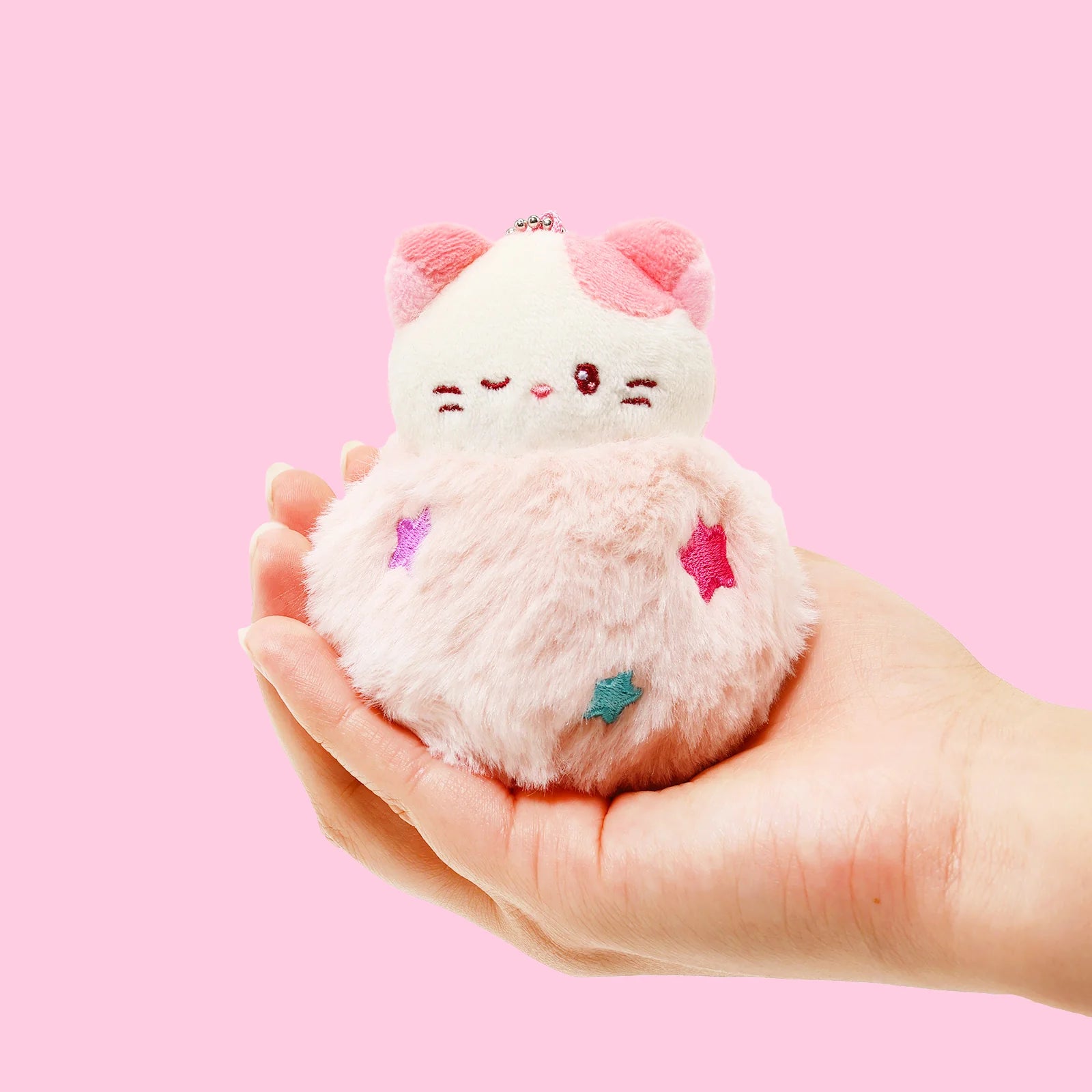 Front view Fluffy Ball Kittiroll Plush Charm hled in palm of hand