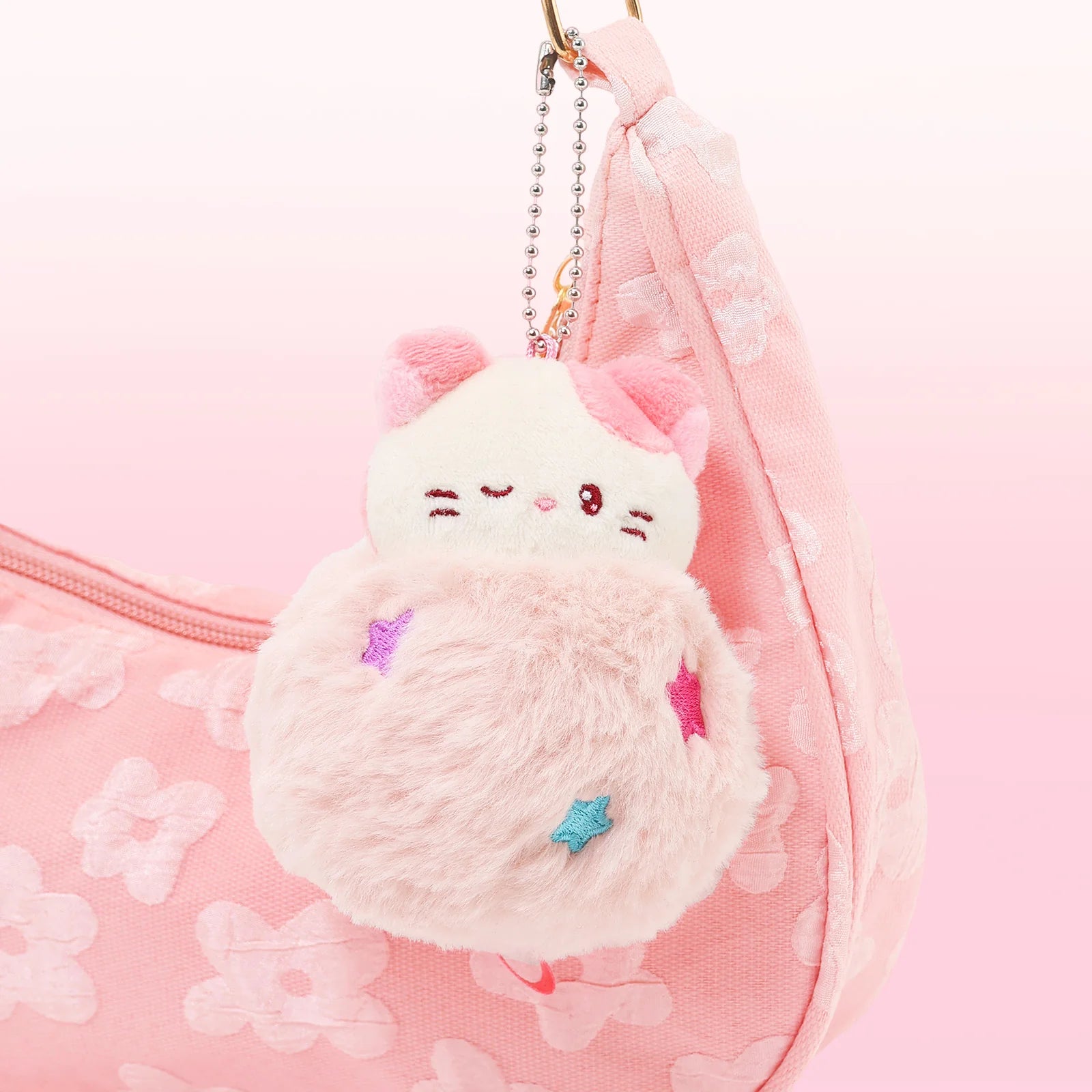 Front view Fluffy Ball Kittiroll Plush Charm tied to Pink Flowers Purse