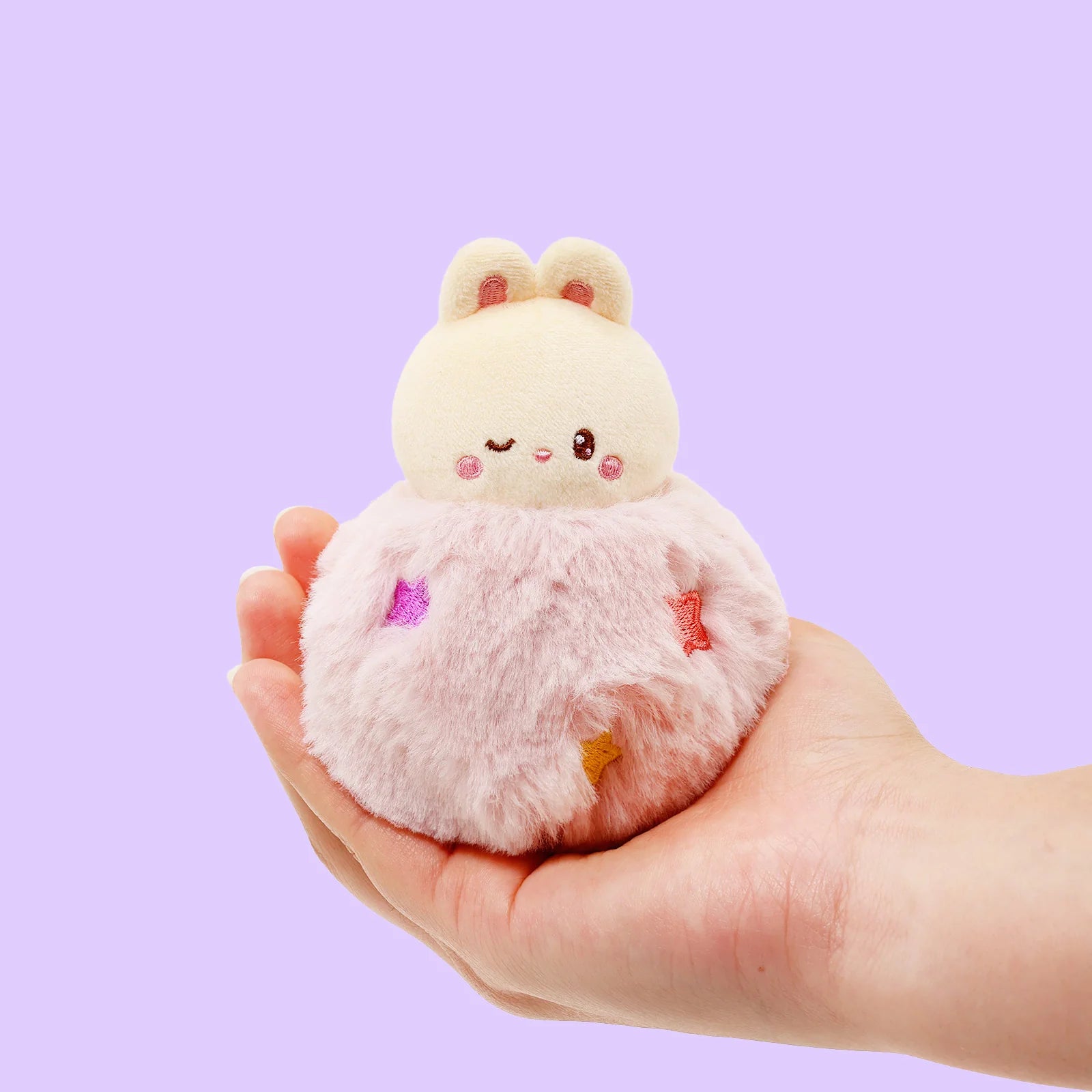 Front view Fluffy Ball Bunniroll Plush Charm held in palm of hand